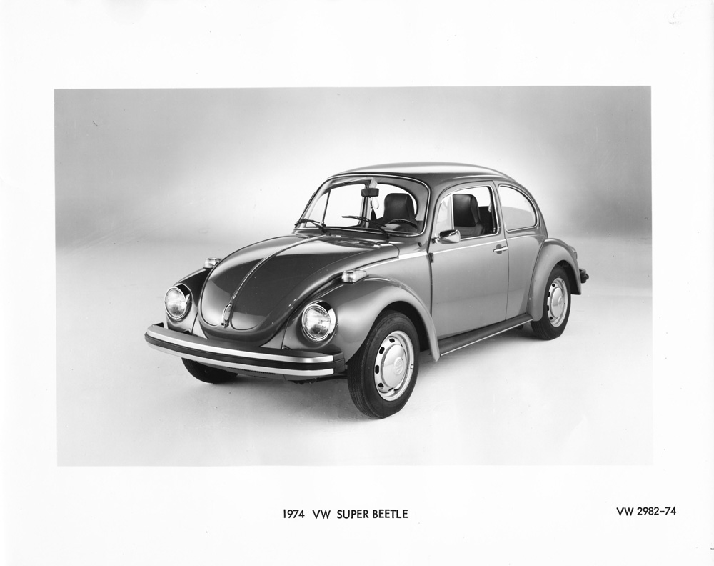 Volkswagen promo picture of a 1974 Volkswagen Super Beetle, a classic compact car known for its iconic design. It features a distinctive curved exterior that improved aerodynamics compared to earlier models.