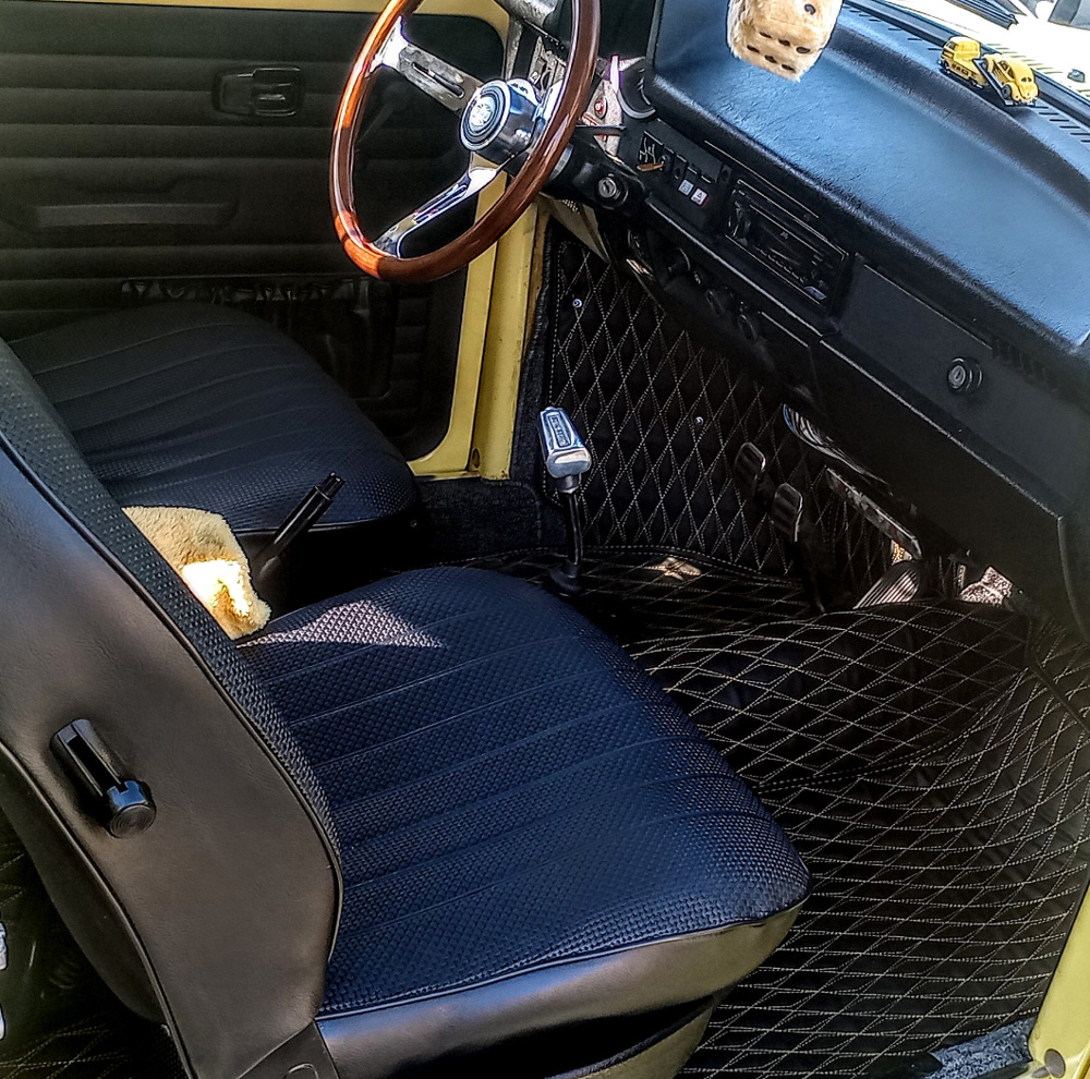 Custom VW interior featuring F1 leather floor mats and a high performance shifter