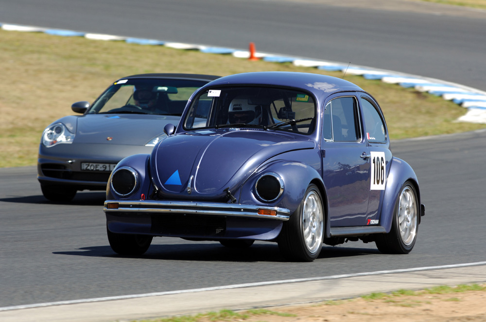 Racing Super Beetles like this are typically heavily modified from their original design for performance, featuring aftermarket parts and racing livery.
