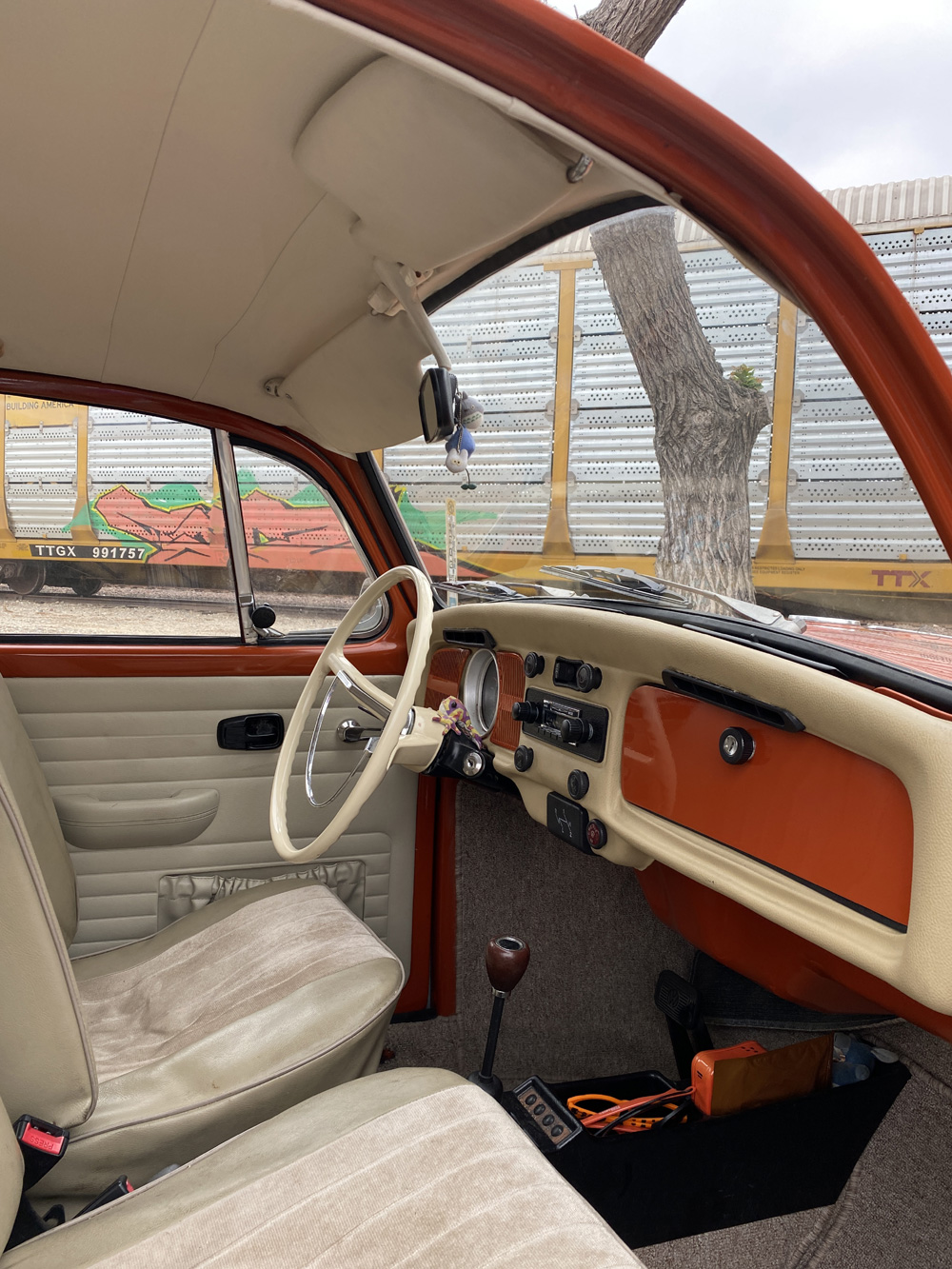 Cream and orange interior of a vintage Volkswagen Beetle.