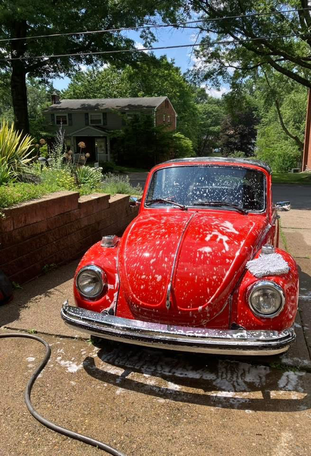 Wash and wax a car then rinse and dry it