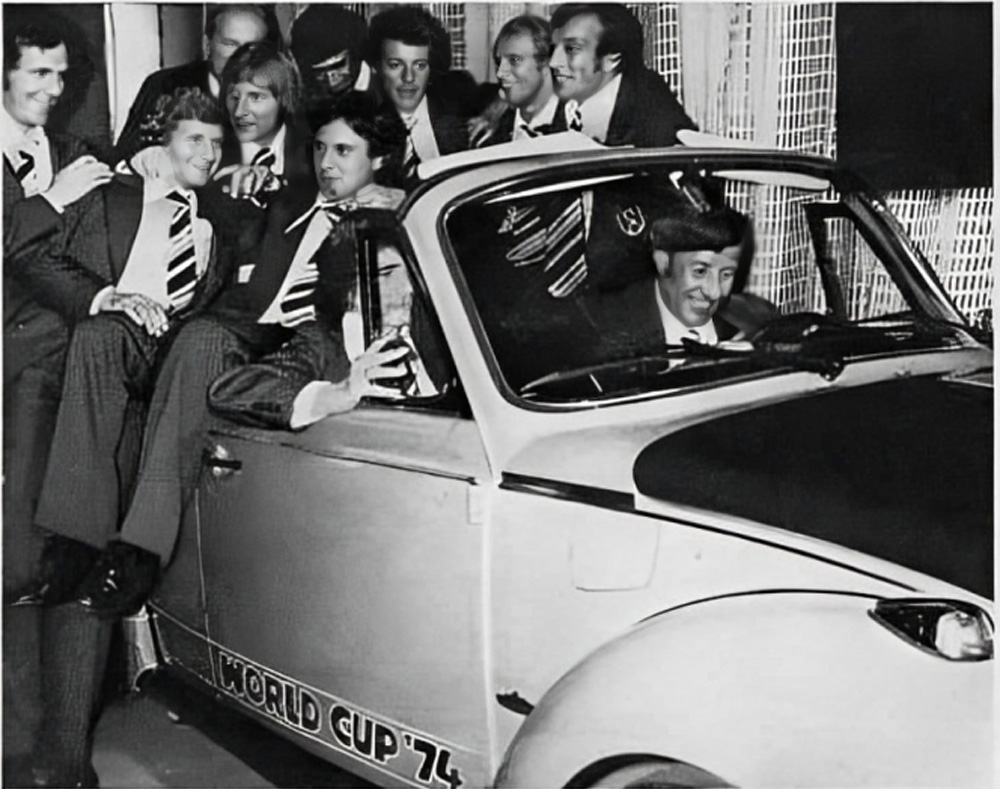 German national team players around a World Cup '74 Super Beetle convertible with coach Helmut Sch&ouml;n at the wheel during the 1974 presentation