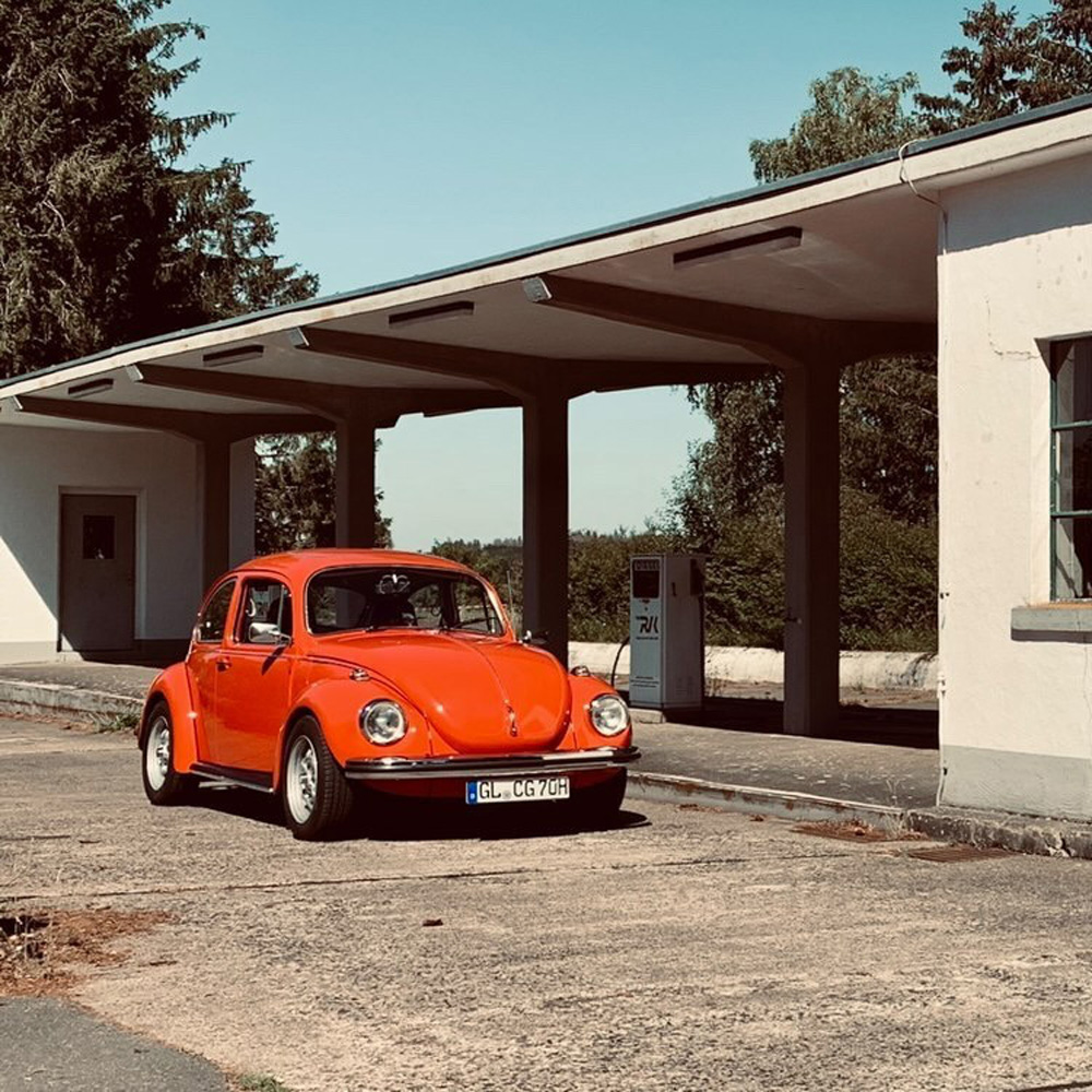 Lowered Beetle by a gas station