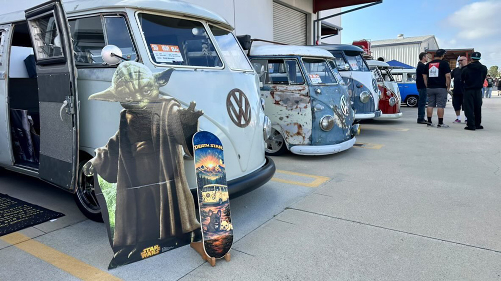 Line of Volkswagen Buses with a Yoda display in front at the EMPI 70th Anniversary Open House