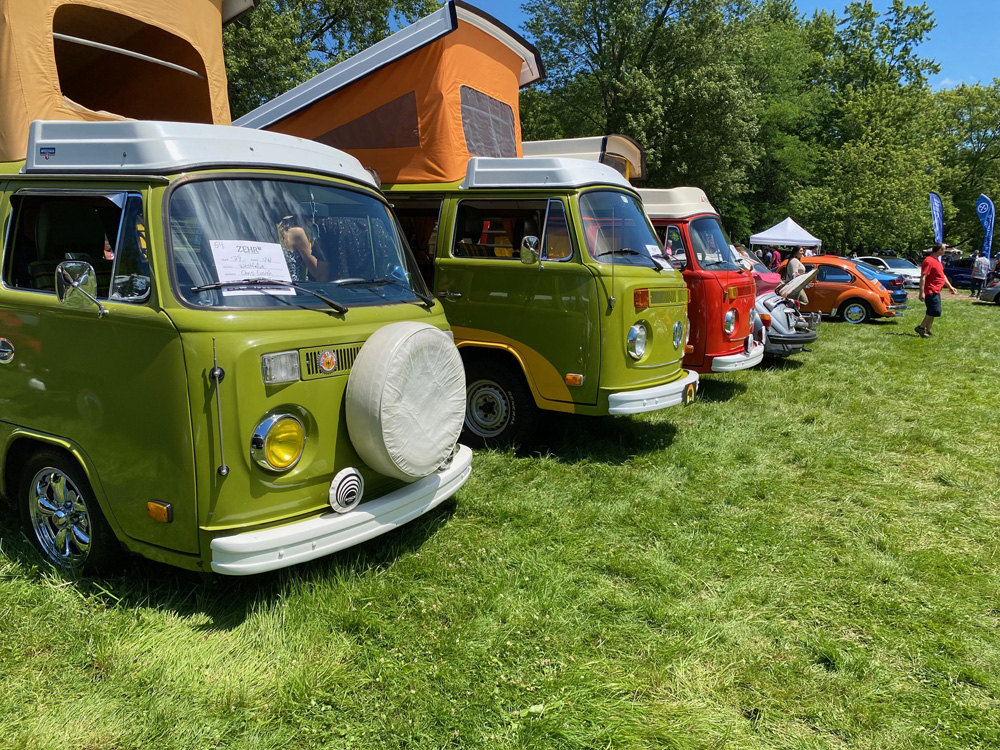 Row of colorful VW camper vans with pop-tops raised at Germanaire 2026