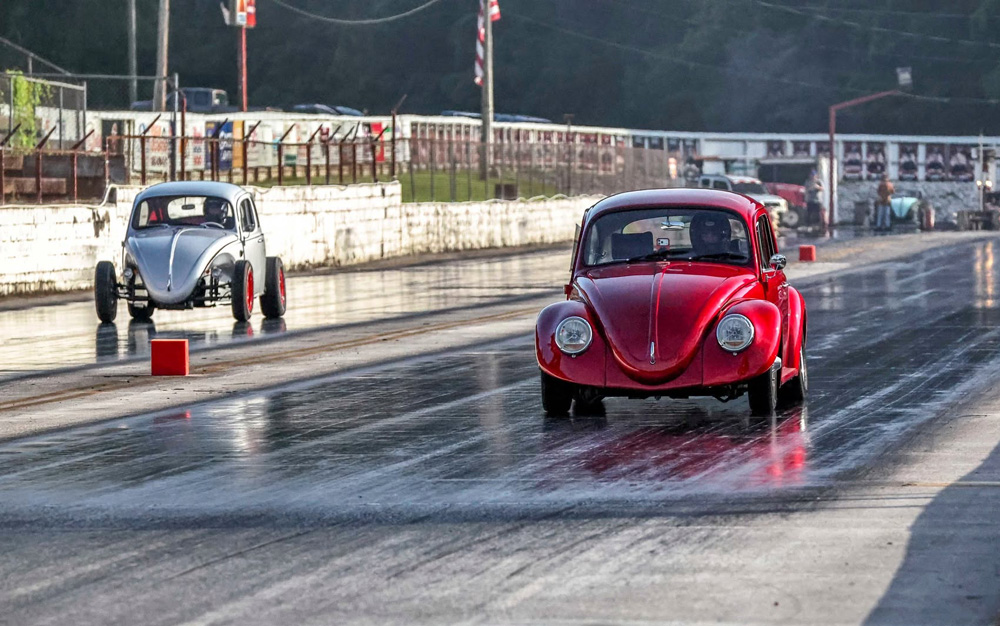 Red and silver modified VW Beetles racing side by side on a drag strip
