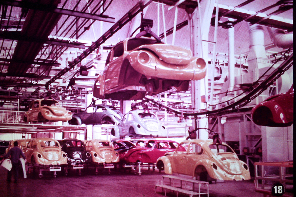 European 1303 Super Beetles are transported by an overhead rail system