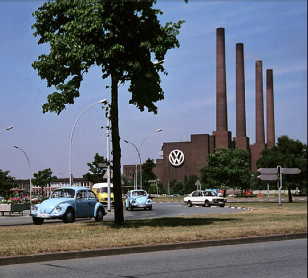 Two Volkswagen Beetle pass just metres away from where they were born at the VW plant in Wolfsburg