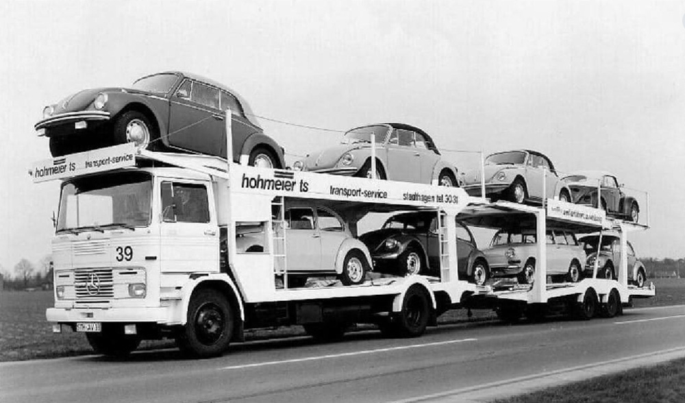 A delivery of new Volkswagens from the Factory, comprising Beetles - including 1303 cabriolets on the top deck - and a Type 3 Variant